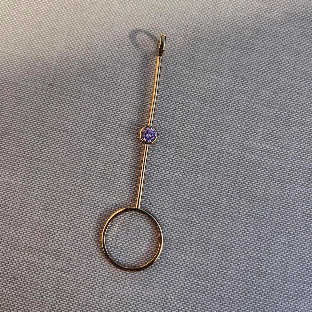 Gold plated cigarette holder (or joint holder) ring with purple stone.